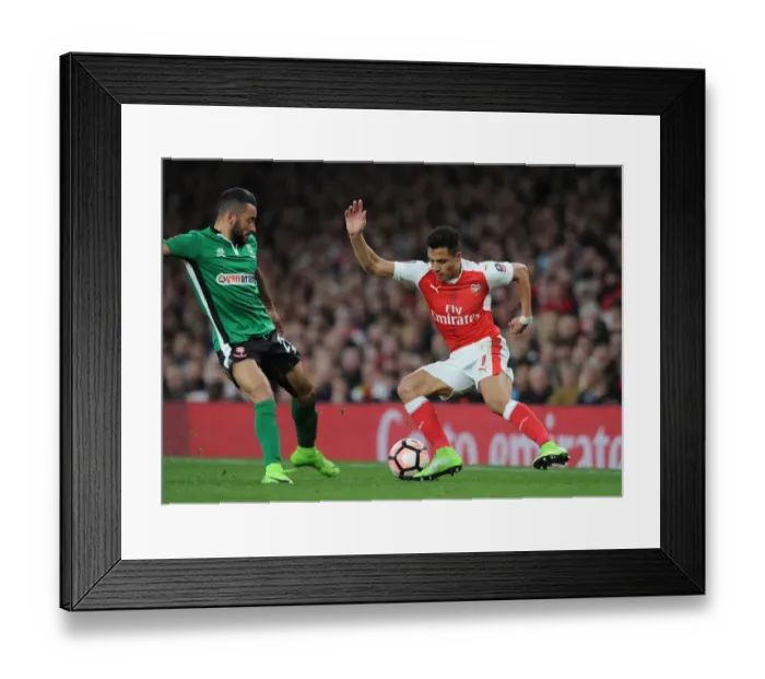 Framed Print : Arsenal vs. Lincoln City: Tense Clash Between Alexis Sanchez and Nathan Arnold in FA Cup Quarter-Final