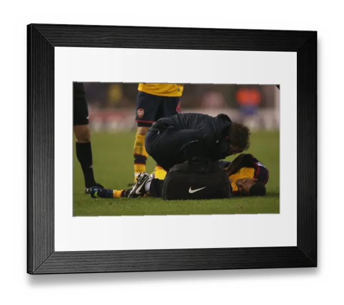 Framed Print : Arsenals Theo Walcott injured after a challenge by Framed Print : Arsenals Theo Walcott injured after a challenge by