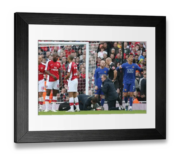 Framed Print : Injured Arsenal goalkeeper Manuel Almunia is treated