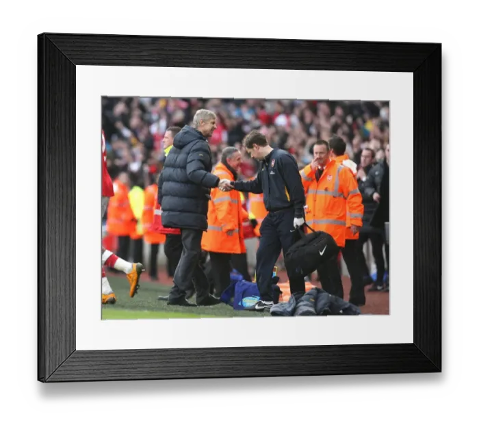 Framed Print : Arsenal manager Arsene Wenger shakes hands with physio Colin Lewin Framed Print : Arsenal manager Arsene Wenger shakes hands with physio Colin Lewin