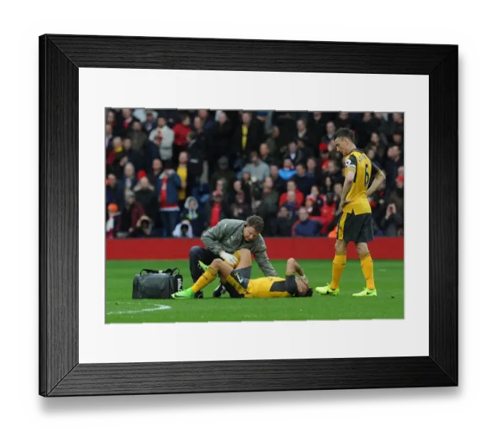 Framed Print : Arsenal: Sanchez Receives Treatment as Koscielny Looks On During West Bromwich Albion Match