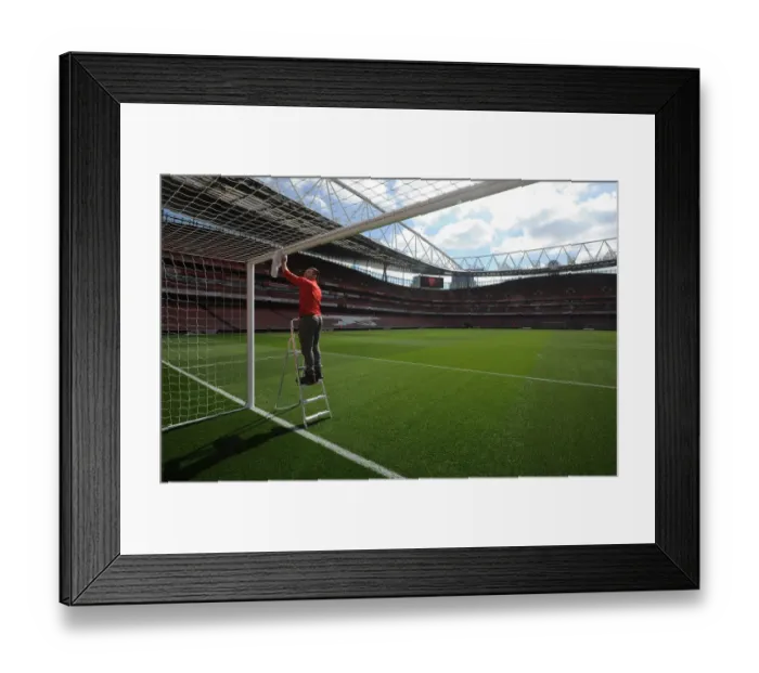 Framed Print : Preparing for the Clash: Arsenal Groundsman Readies Emirates Stadium for Manchester City