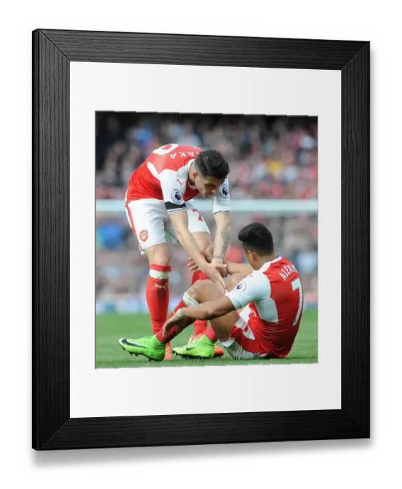 Framed Print : Xhaka Consoles Teammate Sanchez Amidst Arsenal-Manchester City Rivalry