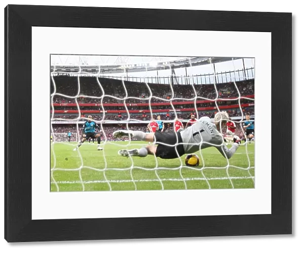 Arsenal goalkeeper Manuel Almunia save a penalty from Ashley Young