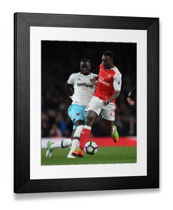 Framed Print : Arsenal's Danny Welbeck Clashes with West Ham's Cheikhou Kouyate during the Premier League Match Framed Print : Arsenal's Danny Welbeck Clashes with West Ham's Cheikhou Kouyate during the Premier League Match