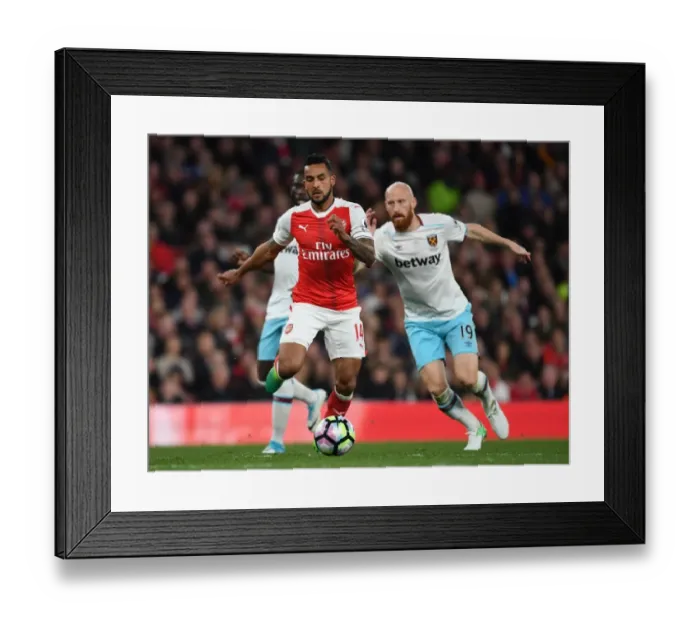 Framed Print : Arsenal's Theo Walcott vs. West Ham's James Collins: A Premier League Battle at Emirates Stadium Framed Print : Arsenal's Theo Walcott vs. West Ham's James Collins: A Premier League Battle at Emirates Stadium