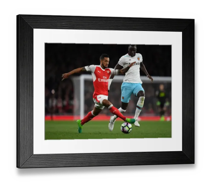 Framed Print : Theo Walcott vs. Cheikhou Kouyate: A Battle at the Emirates - Arsenal v West Ham United, Premier League