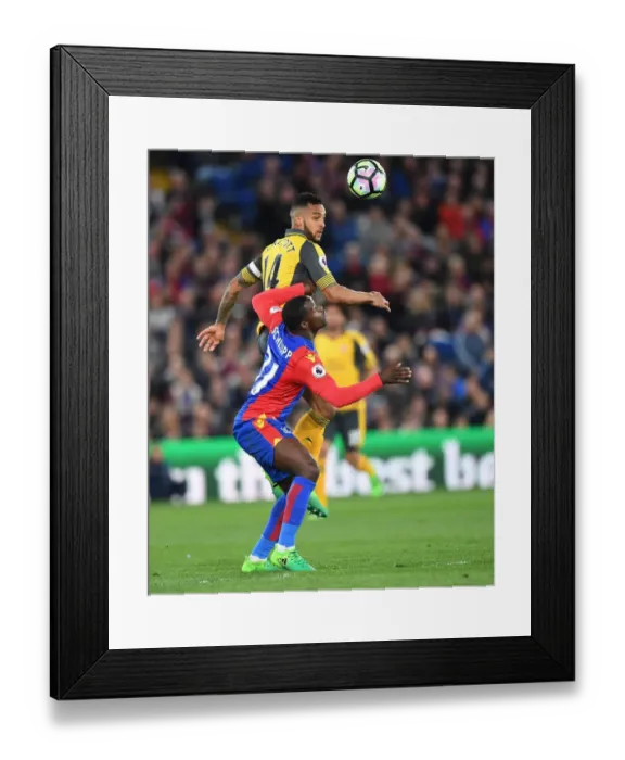 Framed Print : Theo Walcott Leaps Above Jeffrey Schlupp in Crystal Palace vs Arsenal Premier League Clash