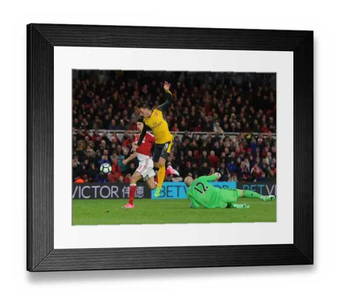 Framed Print : Mesut Ozil vs. Brad Guzan: Intense Clash at Middlesbrough's Riverside Stadium, Premier League 2016-17