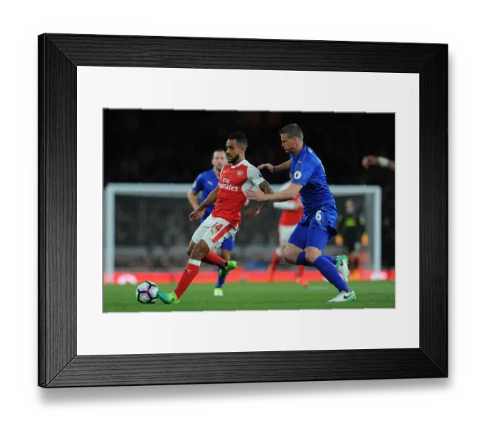 Framed Print : Arsenal's Theo Walcott Faces Off Against Leicester's Robert Huth in Intense Premier League Clash Framed Print : Arsenal's Theo Walcott Faces Off Against Leicester's Robert Huth in Intense Premier League Clash