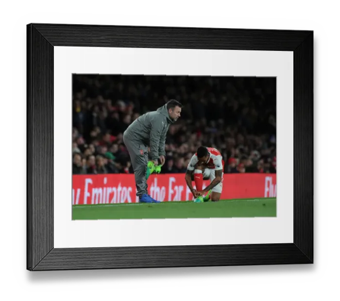 Framed Print : Arsenal: Kitman Paul Akers Prepares Theo Walcott for Arsenal v Leicester City (2016-17)