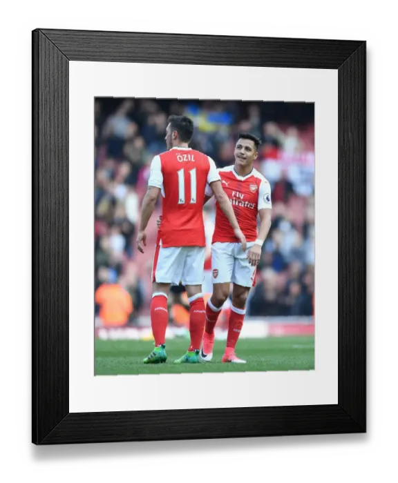 Framed Print : Arsenal's Ozil and Sanchez: A Battle of Stars in Arsenal v Manchester United (2016-17)