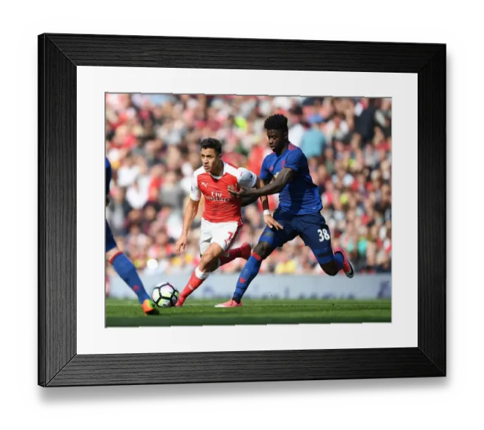 Framed Print : Arsenal's Alexis Sanchez Outmaneuvers Manchester United's Axel Tuanzebe during the Premier League Clash Framed Print : Arsenal's Alexis Sanchez Outmaneuvers Manchester United's Axel Tuanzebe during the Premier League Clash