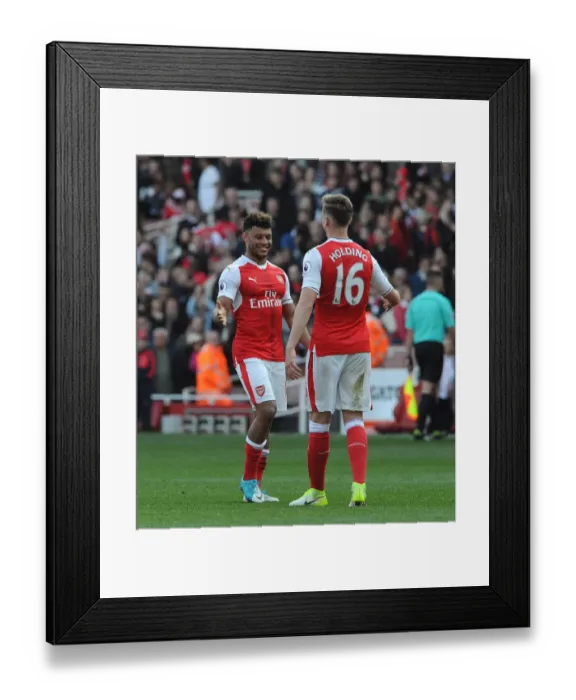 Framed Print : Arsenal Celebrate Victory: Oxlade-Chamberlain and Holding Embrace Post-Match at Emirates Stadium