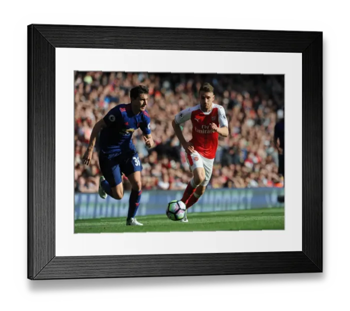 Framed Print : Arsenal's Aaron Ramsey Closes In on Manchester United's Matteo Darmian in Intense Premier League Showdown Framed Print : Arsenal's Aaron Ramsey Closes In on Manchester United's Matteo Darmian in Intense Premier League Showdown