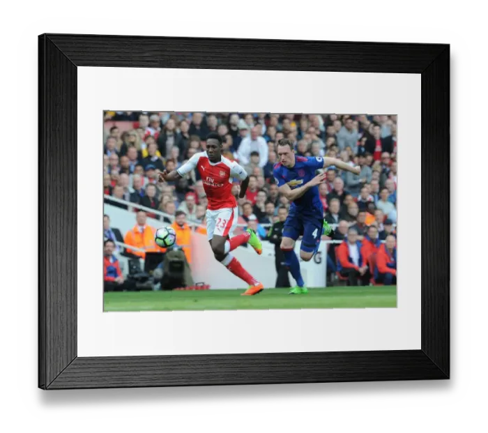 Framed Print : Arsenal's Danny Welbeck Clashes with Manchester United's Phil Jones in Premier League Showdown Framed Print : Arsenal's Danny Welbeck Clashes with Manchester United's Phil Jones in Premier League Showdown