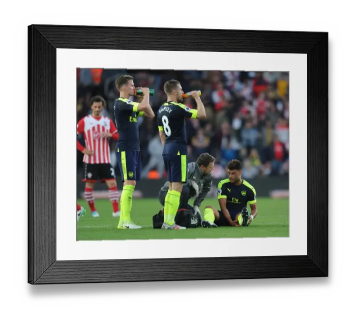 Framed Print : Alex Oxlade-Chamberlain Receives Treatment from Arsenal Physio Colin Lewin during Southampton vs Arsenal Match, 2017 Framed Print : Alex Oxlade-Chamberlain Receives Treatment from Arsenal Physio Colin Lewin during Southampton vs Arsenal Match, 2017