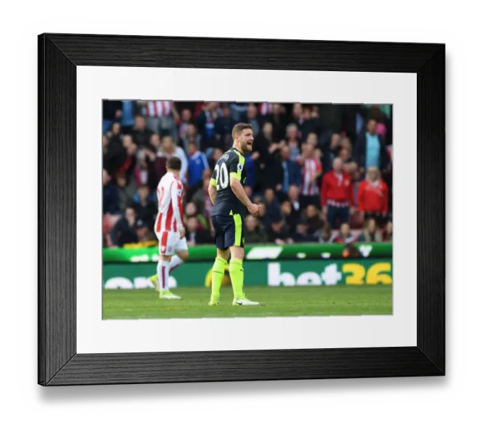 Framed Print : Shkodran Mustafi Focuses in Stoke City vs Arsenal Premier League Clash