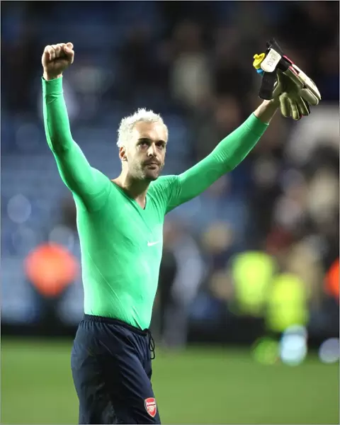 Arsenal goalkeeper Manuel Amunia salutes the fans after the match