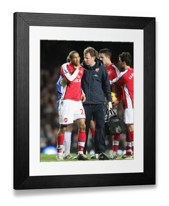 Framed Print : Arsenal physio Colin Lwein treats Gael Clichy Framed Print : Arsenal physio Colin Lwein treats Gael Clichy