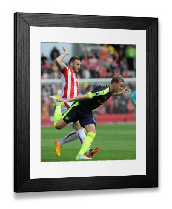 Framed Print : Arsenal's Dominance: Rob Holding Scores Against Marko Arnautovic as Arsenal Thrash Stoke 4-1 in Premier League Framed Print : Arsenal's Dominance: Rob Holding Scores Against Marko Arnautovic as Arsenal Thrash Stoke 4-1 in Premier League