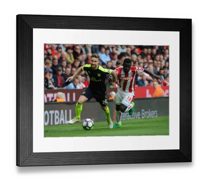 Framed Print : Mustafi vs Diouf: Intense Battle in Stoke City vs Arsenal Premier League Clash