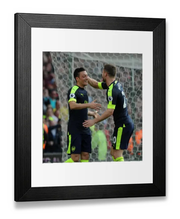 Framed Print : Mesut Ozil and Shkodran Mustafi Celebrate Arsenal's Second Goal Against Stoke City Framed Print : Mesut Ozil and Shkodran Mustafi Celebrate Arsenal's Second Goal Against Stoke City