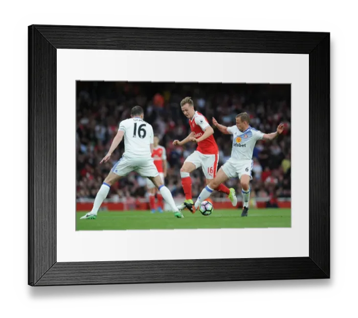 Framed Print : Arsenal's Rob Holding Clashes with Sunderland's John O'Shea and Lee Catermole during the Premier League Match