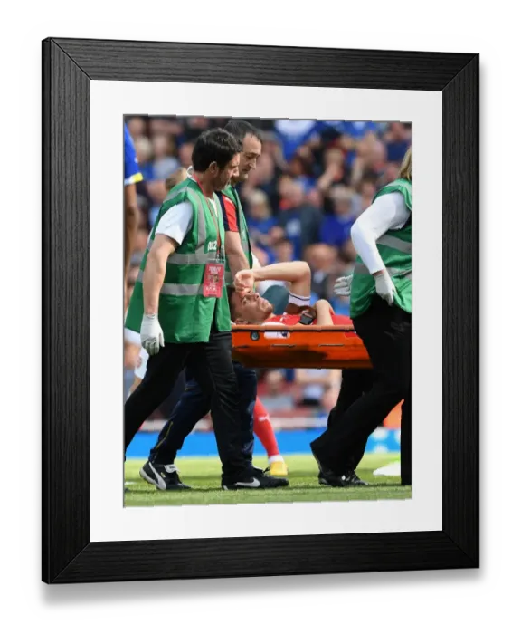 Framed Print : Arsenal's Injured Gabriel Carried Off the Pitch During Arsenal v Everton Match