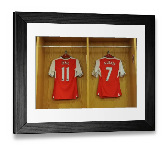 Framed Print : Arsenal's Ozil and Sanchez Jerseys Hang in Empty Changing Room before Arsenal v Everton (2016-17) Framed Print : Arsenal's Ozil and Sanchez Jerseys Hang in Empty Changing Room before Arsenal v Everton (2016-17)