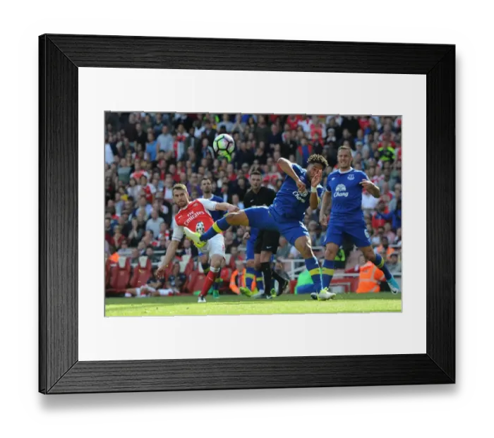 Framed Print : Aaron Ramsey Scores Dramatic Third Goal Past Ashley Williams in Arsenal's Victory over Everton