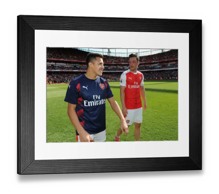 Framed Print : Mesut Ozil and Alexis Sanchez: A Moment of Connection at Arsenal's Emirates Stadium (Arsenal v Everton 2016-17)