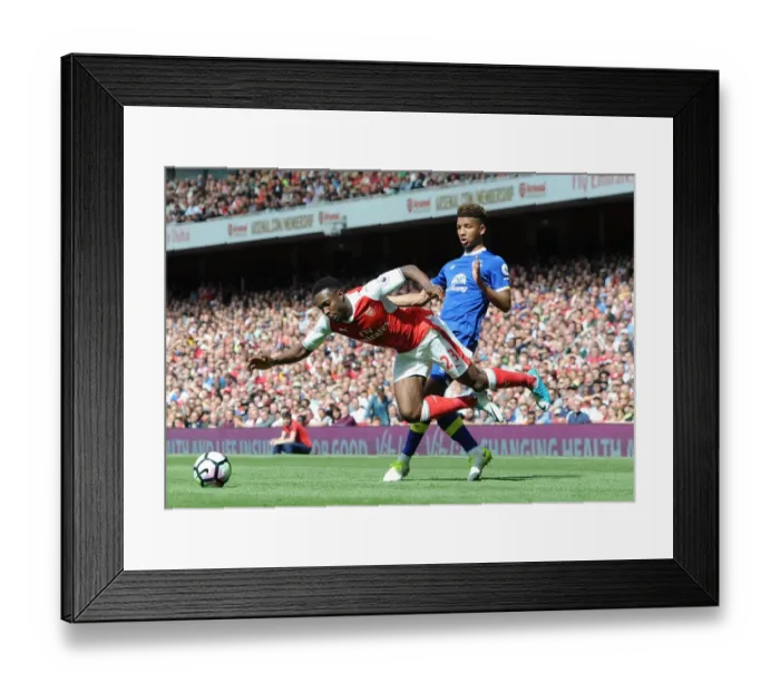 Framed Print : Arsenal's Danny Welbeck Fouled by Everton's Mason Holgate in Intense Premier League Clash Framed Print : Arsenal's Danny Welbeck Fouled by Everton's Mason Holgate in Intense Premier League Clash