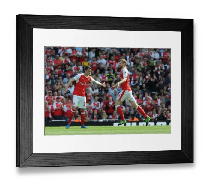 Framed Print : Mertesacker Welcomes Xhaka: A Moment of Camaraderie at Arsenal's Emirates Stadium