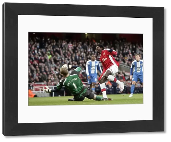 Emmanuel Adebayor scores Arsenals goal past Chris Kirkland (Wigan)