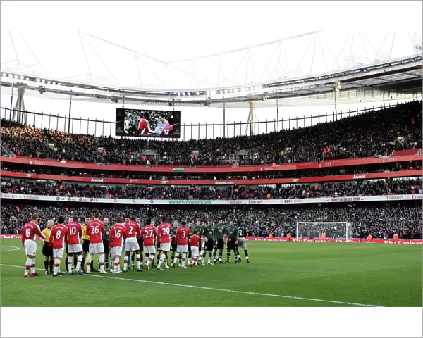 The Arsenal and Plymouth players shake hands before the match