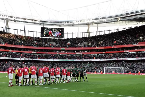 The Arsenal and Plymouth players shake hands before the match