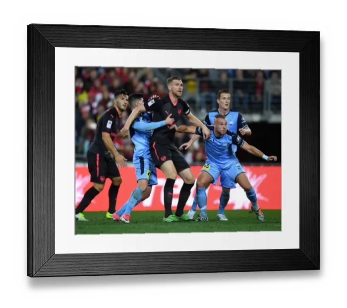 Framed Print : Clash in Sydney: Per Mertesacker Faces Off Against Paulo Retre and Jordy Bujis of Sydney FC