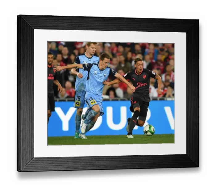 Framed Print : Mesut Ozil Outmaneuvers Brandon O'Neill: Sydney FC vs. Arsenal Pre-Season Clash