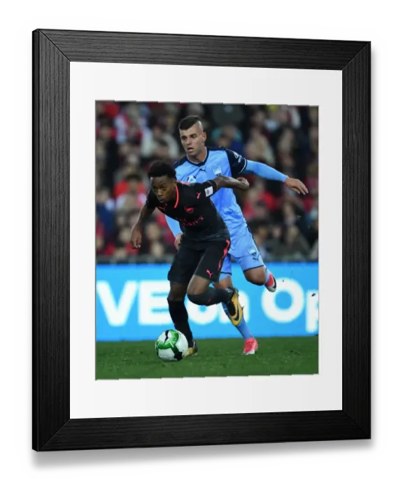 Framed Print : Arsenal's Joe Willock Outshines Sydney FC's Christopher Zuvela: Young Gun's Agile Moves in Pre-Season Clash
