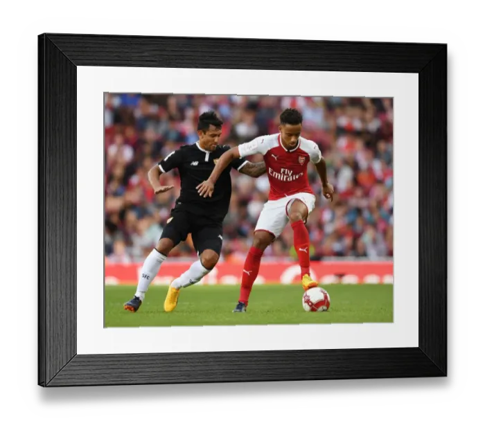 Framed Print : Arsenal's Cohen Bramall Clashes with Sevilla's Walter Montoya during the Emirates Cup Match