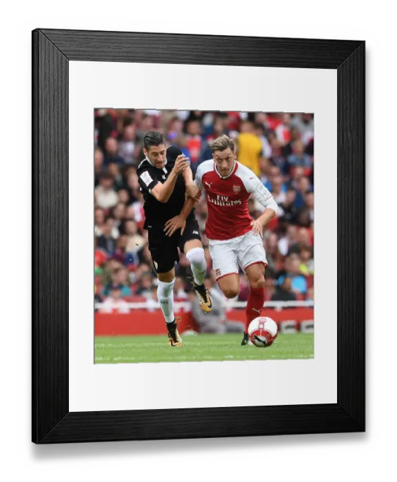 Framed Print : Mesut Ozil vs. Sergio Escudero: Arsenal vs. Sevilla - Emirates Cup Showdown