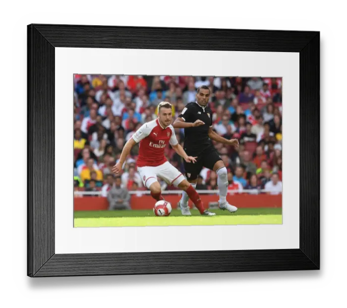 Framed Print : Arsenal's Aaron Ramsey Faces Off Against Sevilla's Gabriel Mercado in Emirates Cup Clash