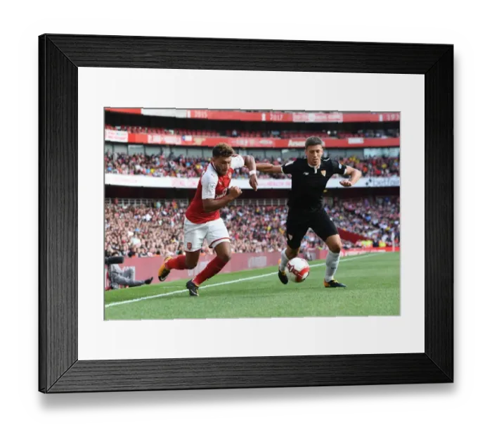 Framed Print : Arsenal's Oxlade-Chamberlain vs. Sevilla's Corchia: Emirates Cup Showdown Framed Print : Arsenal's Oxlade-Chamberlain vs. Sevilla's Corchia: Emirates Cup Showdown