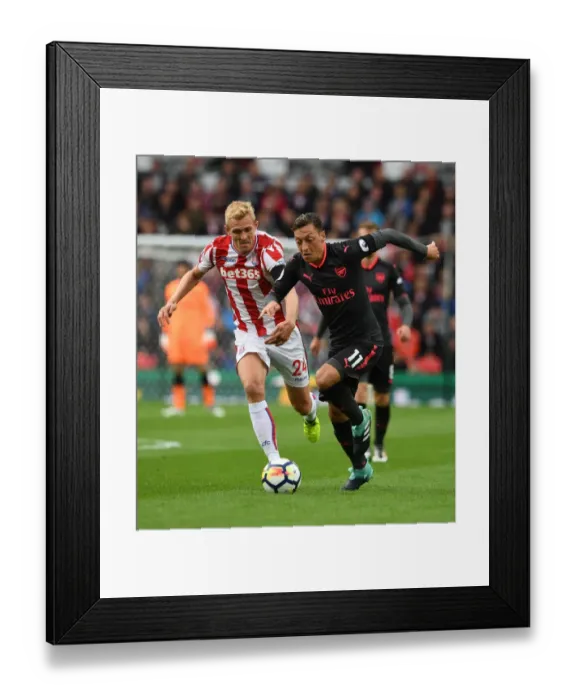 Framed Print : Mesut Ozil vs Darren Fletcher: A Premier League Battle at Bet365 Stadium