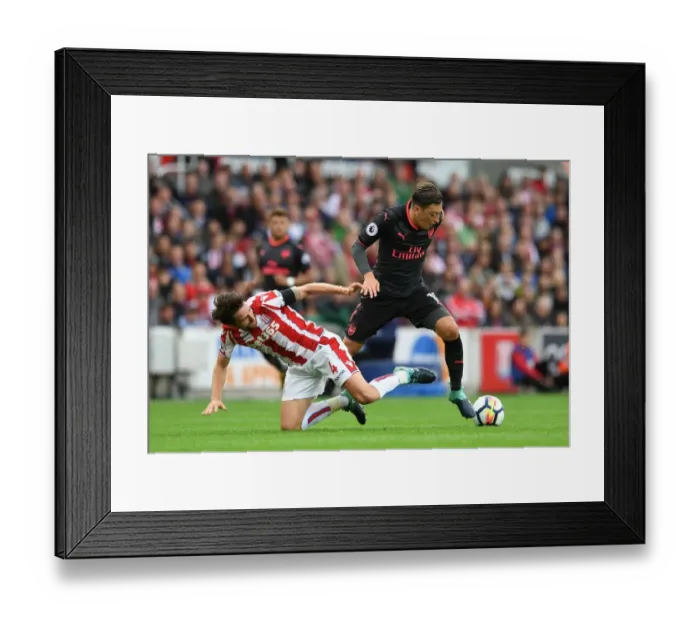 Framed Print : Mesut Ozil vs Joe Allen: A Premier League Battle at Stoke City