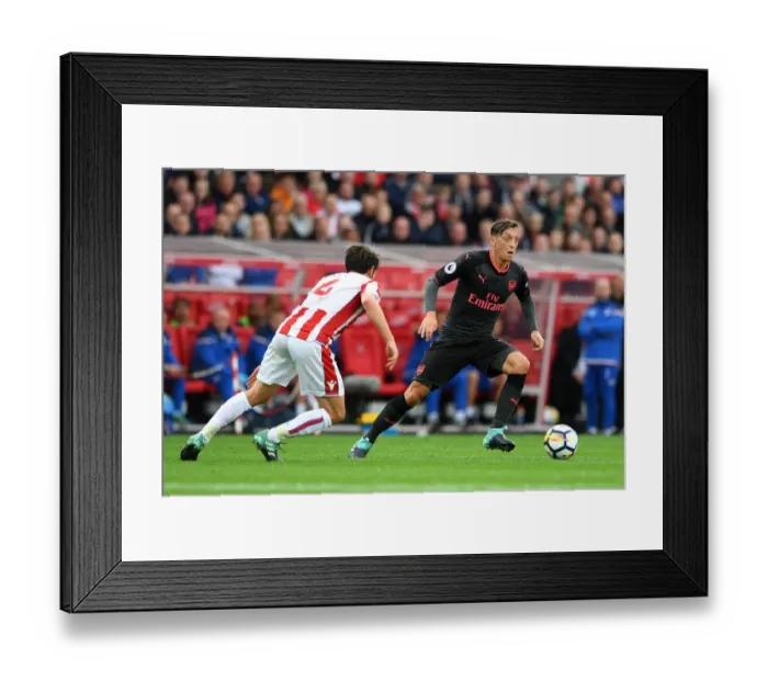Framed Print : Mesut Ozil vs Joe Allen: Intense Battle in Stoke City vs Arsenal Premier League Clash Framed Print : Mesut Ozil vs Joe Allen: Intense Battle in Stoke City vs Arsenal Premier League Clash