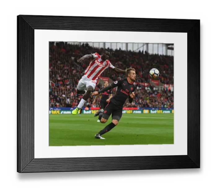 Framed Print : Clash at the Bet365: Ramsey vs. Diouf in Stoke-Arsenal Premier League Showdown Framed Print : Clash at the Bet365: Ramsey vs. Diouf in Stoke-Arsenal Premier League Showdown