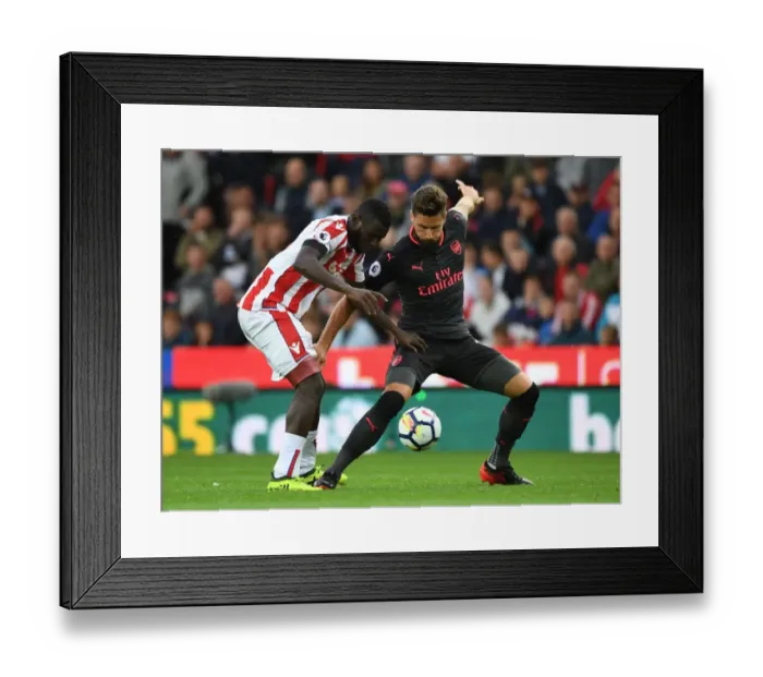 Framed Print : Giroud vs Diouf: A Battle at Bet365 Stadium - Stoke City vs Arsenal, Premier League 2017-18