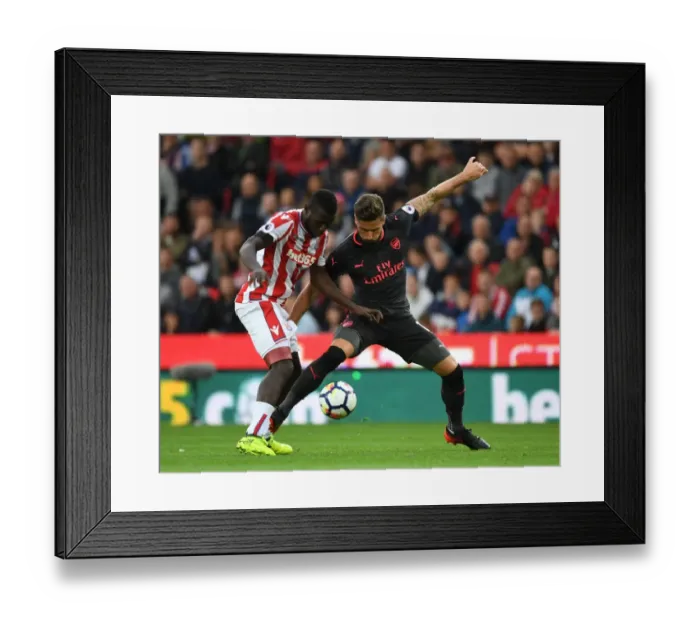 Framed Print : Giroud vs Diouf: Clash at the Bet365 Stadium - Stoke City vs Arsenal, Premier League 2017-18